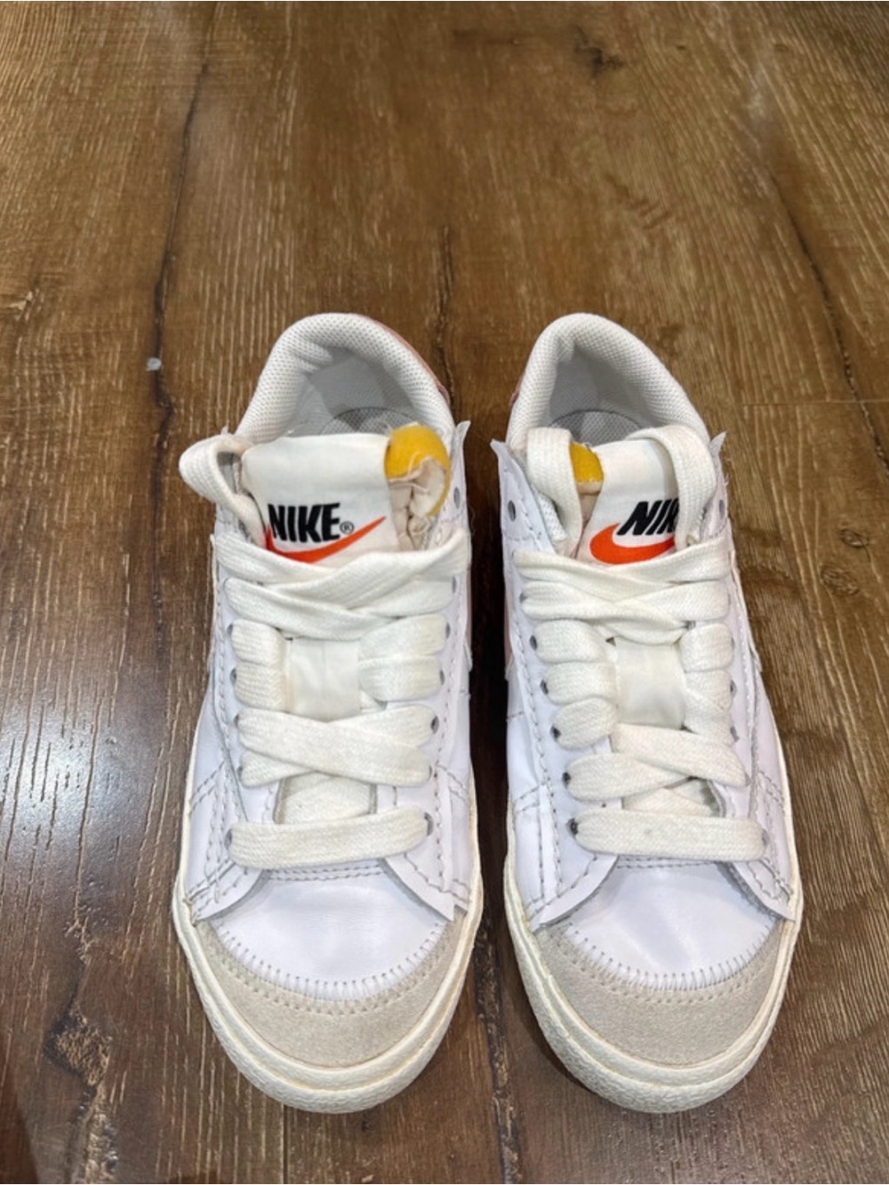 Nike Kids White Sneakers with Orange Swoosh and Yellow Tongue Detail